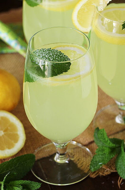 Glass of Limoncello Lemonade Garnished with a Mint Leaf and Lemon Slice Image