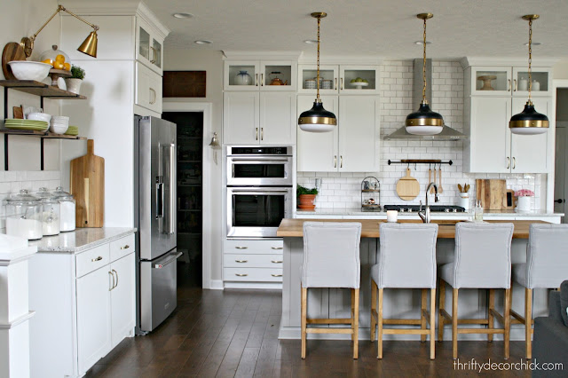 Black and brass pendant lights over island