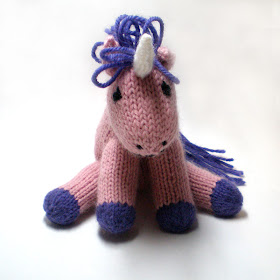 A knitted pink grumpy unicorn called Hubert