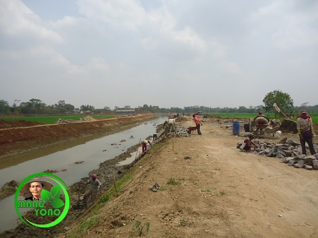  Pemasangan batu penahan tanah bibir saluran sungai Bendungan Macan.