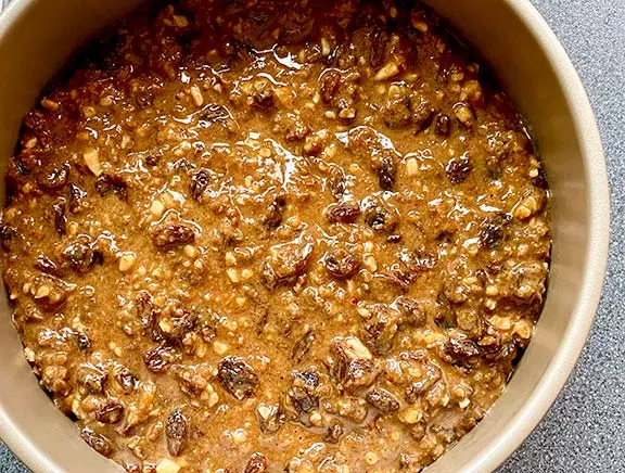 Fruit cake in a cake tin ready to cook.