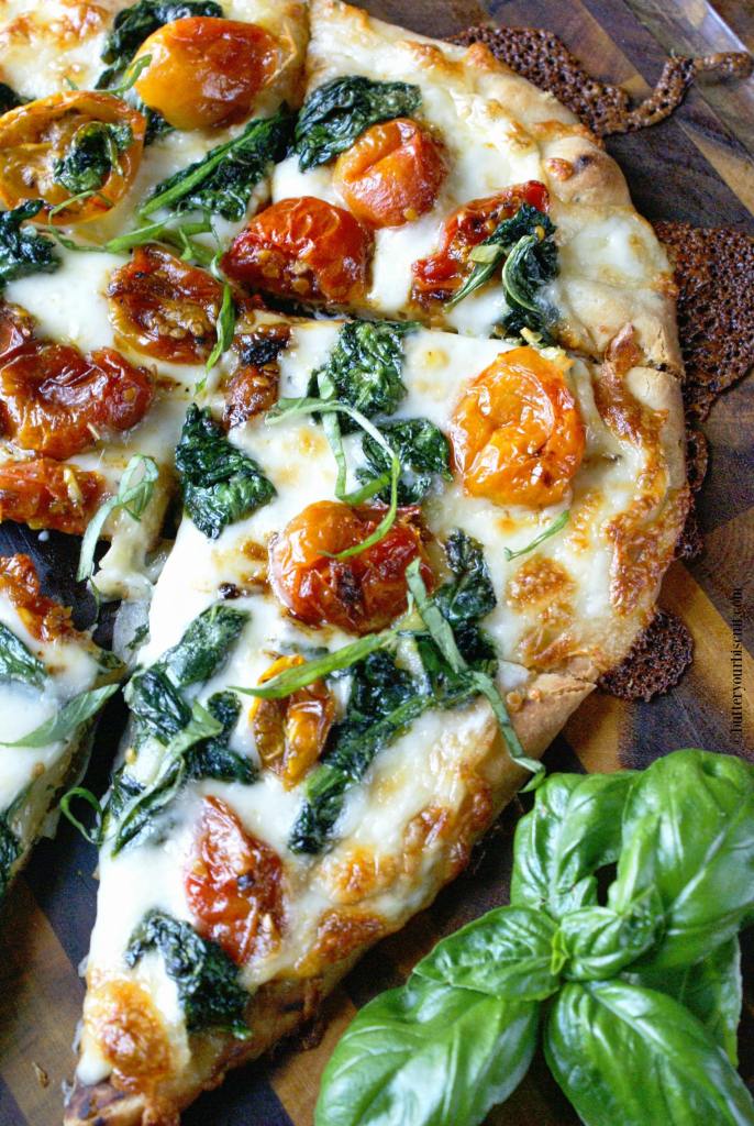 Garlic Roasted Tomato Flatbread - Flatbread makes a fantastic appetizer or light meal. Topped with sweet roasted cherry tomatoes, and spinach will make you keep wanting one more bite.