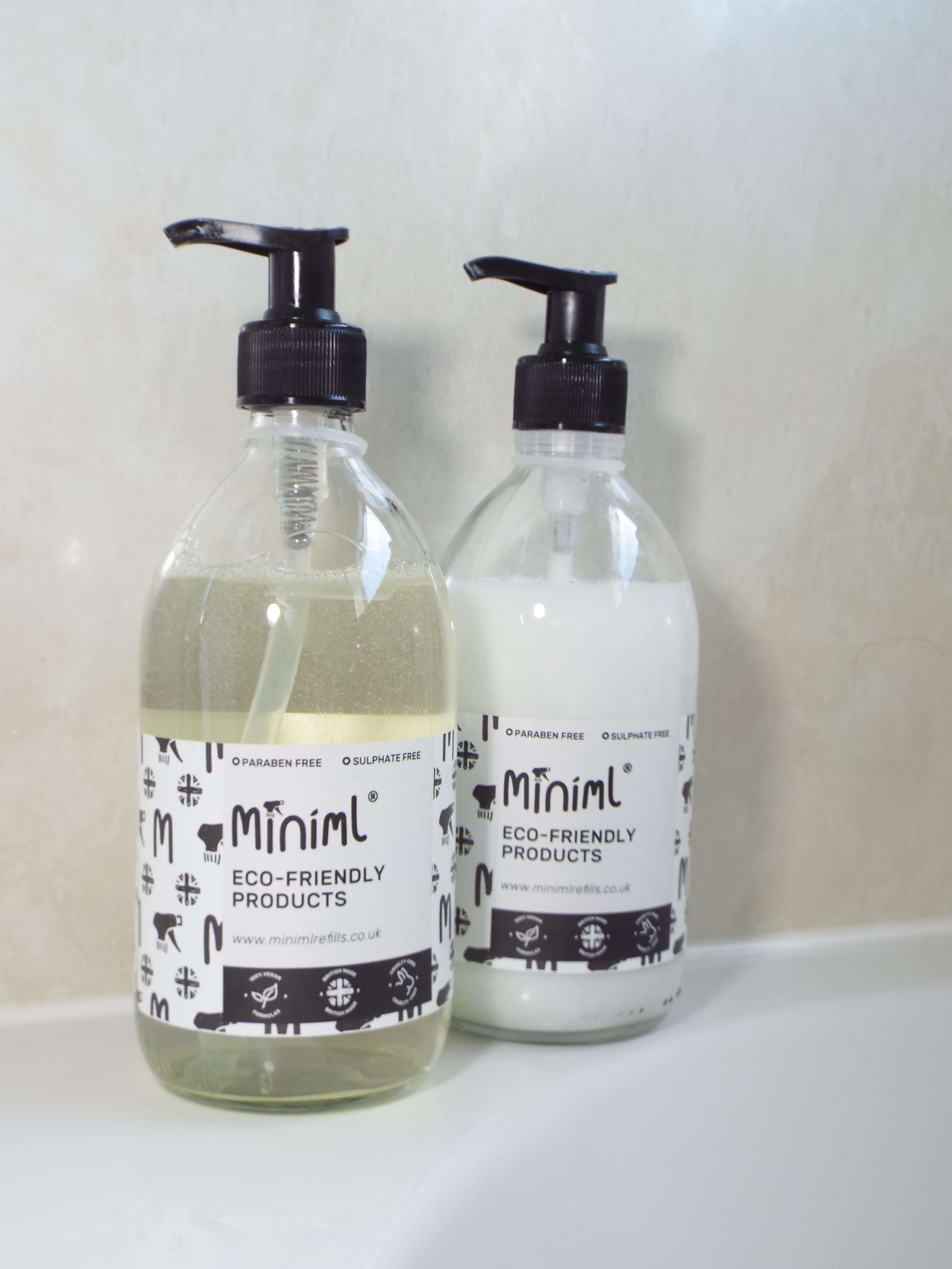 Minimal refillable shampoo and conditioner on bath side.