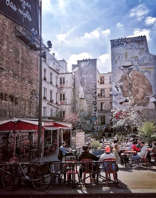 Wall art and cafe terrace inParis