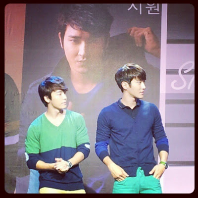 Siwon and Donghae in Trinoma with Siwon's Poster in the background