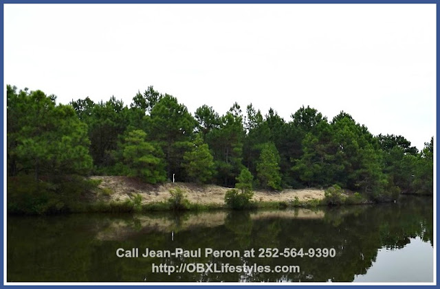 There is nothing like escaping the pavement on this idyllic canalfront Outer Banks NC lot for sale.