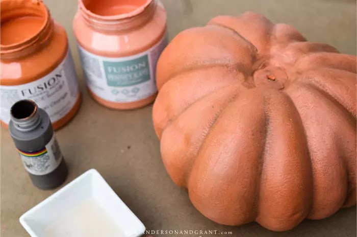 Plastic pumpkin being painted for DIY project