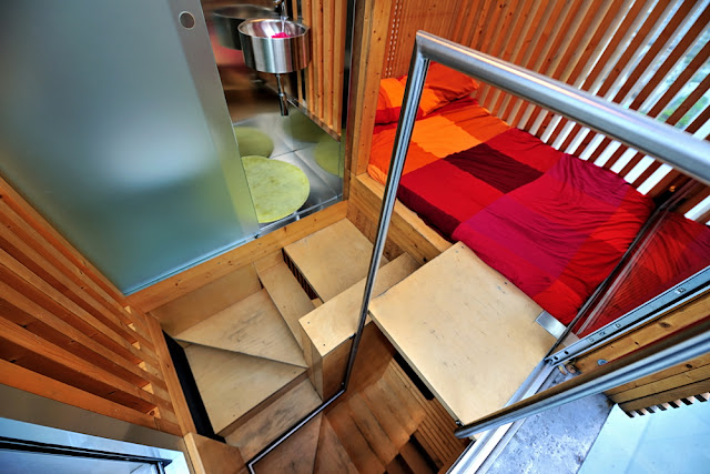 Photo of the narrow wooden staircase to the small bedroom level