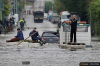 Residents who refused to be evacuated sit on makeshift boats during evacuation operations of the Villeneuve-Trillage suburb of Paris on June 3, 2016. (Credit: Reuters/Christian Hartmann) Click to Enlarge.