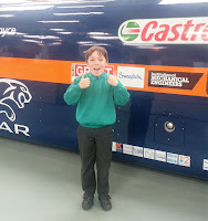 Boy in school holding visitors badge