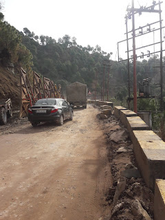 Car and truck passing on a road in the mountains