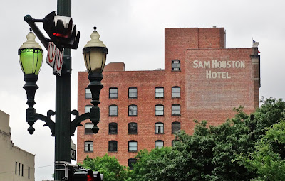 Sam Houston Hotel with vintage street lamps on Main in foreground 