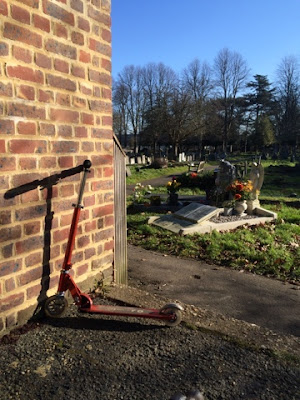 Autistic child scooter on school run through cemetery