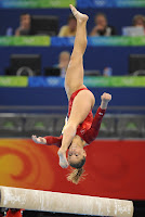 Shawn Johnson in the middle of a flip on the balance beam