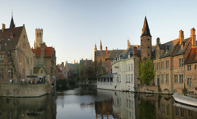 A canal in Bruges with the famous Belfry in the background