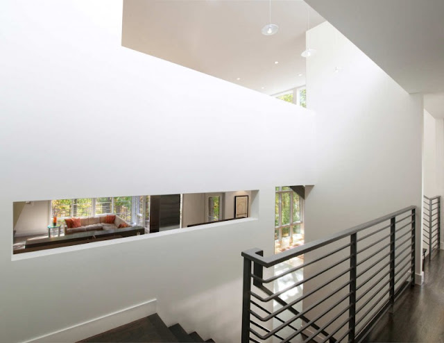 White Concrete Wall and Several White Bulb Hanged in the Ceiling
