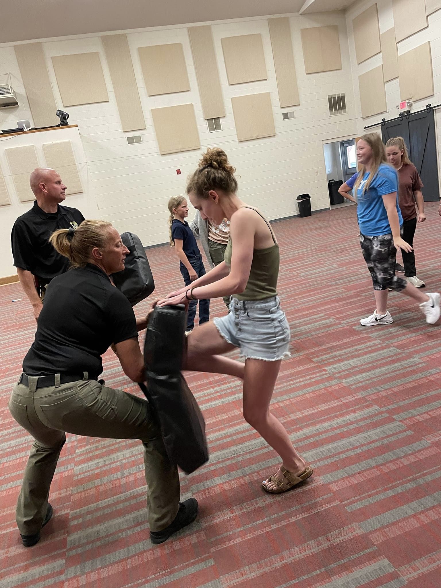 Group of women practicing self-defense techniques in a class.