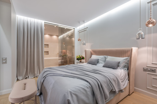 A bedroom with dominant neutral tones, featuring recessed LED strip lights.