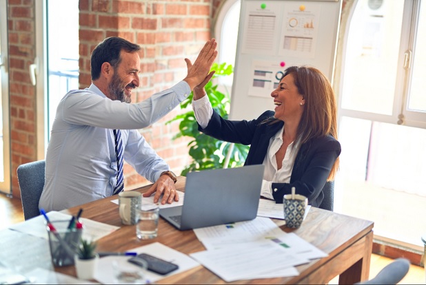 A sales rep and her manager are celebrating after successfully close a deal using unique sales technique