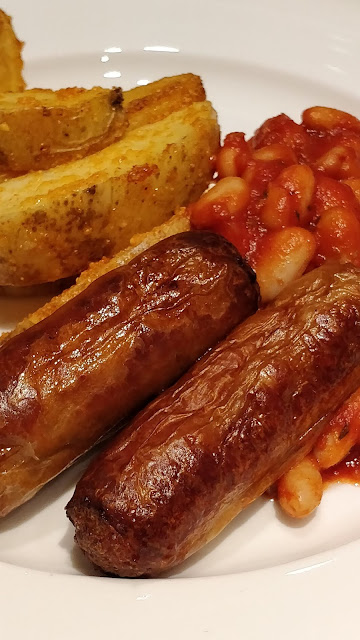 homemade baked beans, parmesan wedges and Richmond chicken sausages