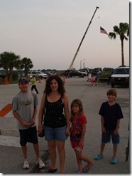 Big Flag in background hoisted on crane.