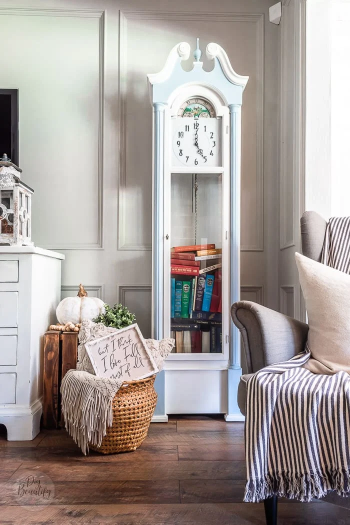 grandfather clock painted blue and white filled with vintage books