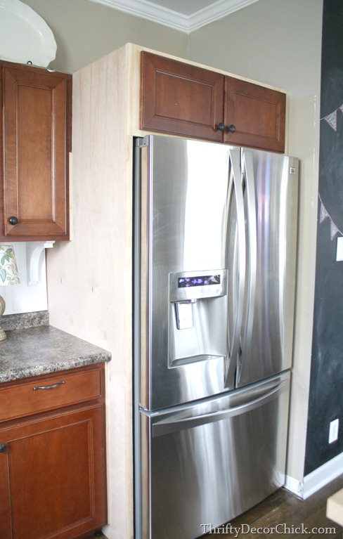 building in refridgerator with cabinet on top