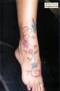Flores e borboleta tatuadas no pé.