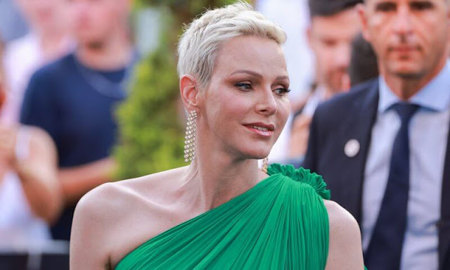 Princess Charlene wore a green flared-hem one-shoulder maxi dress by Lanvin Paris. Diamond earrings and dior sandals