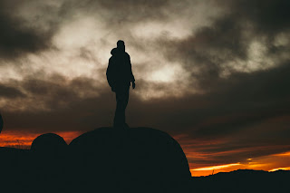 man in the dark moody clouds.