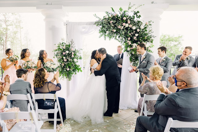 bride and groom kissing during ceremony