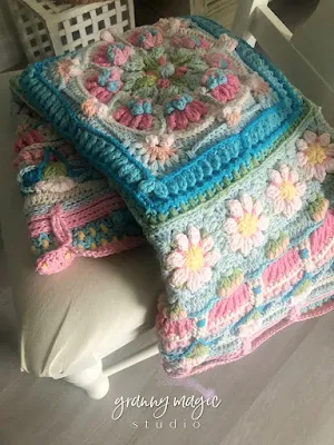 Crochet blanket on chair in morning sunlight.
