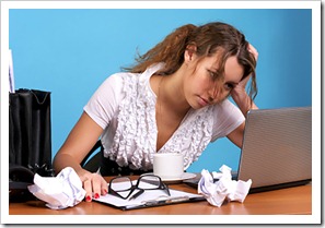 Tired business woman looking at laptop