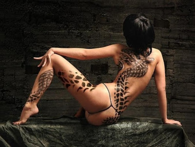 Body Painting an attractive promo girl with a hot body 