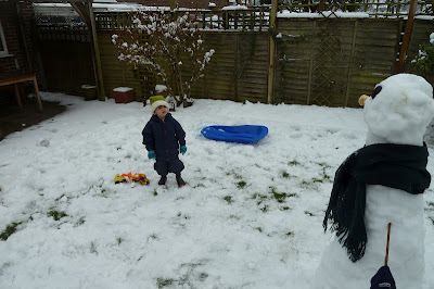 Snow day with children in the garden