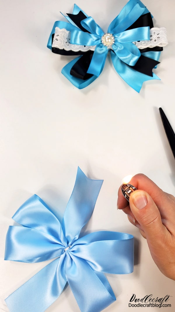 Step 4: Lighter time!   Carefully use the lighter to melt the ends of the ribbon.   Not too much or too close or you will warp the ends!   Practice on a scrap before doing your bow.
