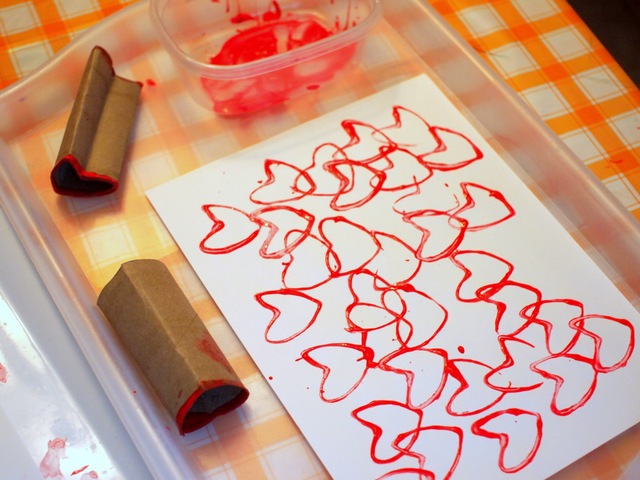 stamping hearts with toilet paper rolls and tempera paint