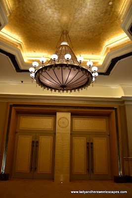 golden doors and chandelier inside Abu Dhabi's Emirates Palace