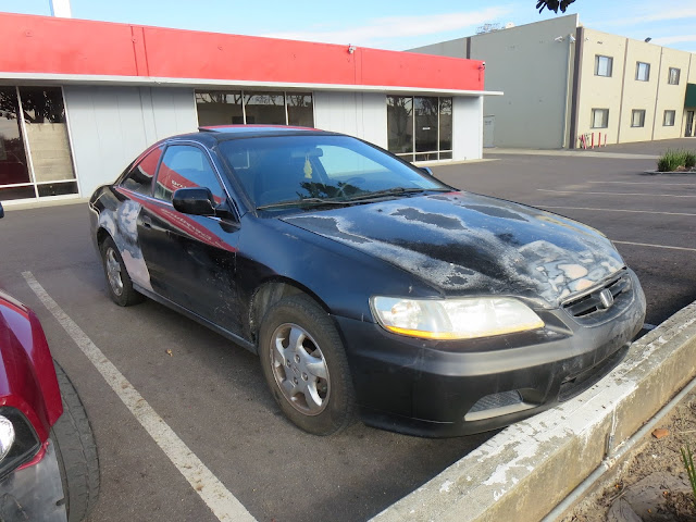 Accord covered in primer and peeling clear coat before painting at Almost Everything Auto Body