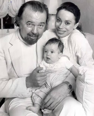 Rebecca Hall with her father and mother at infant age