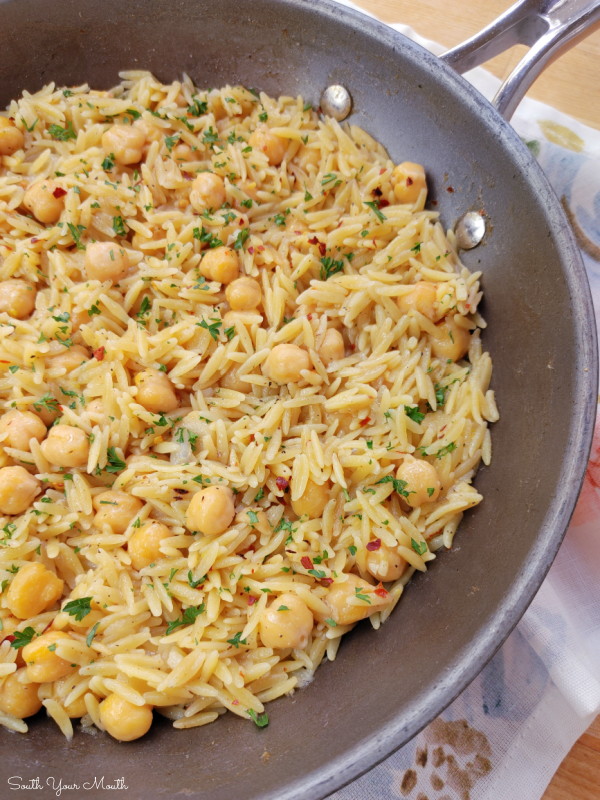 Spicy Chickpeas with Orzo! A Mediterranean inspired recipe with chickpeas (garbanzo beans), orzo and layers of spices and mild heat that doubles as the perfect side or a meatless main dish.