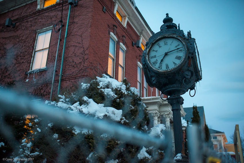 Portland, Maine USA March 2017 photo by Corey Templeton. Looking up at the old clock at 749 Congress Street, in the West End. The building behind it, a former funeral home, has been vacant for years but is currently being redeveloped into a hotel, spa, and restaurant.