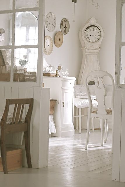 White Swedish style dining room with white Mora clock - found on Hello Lovely Studio