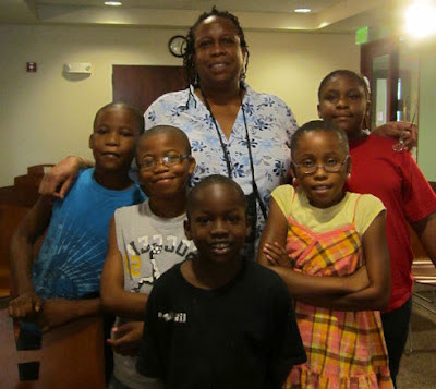 Library employee with group of children