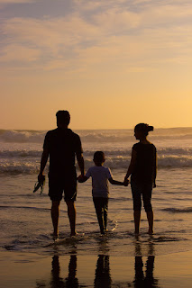 Family holidays in Crete, couple and kid on the beach