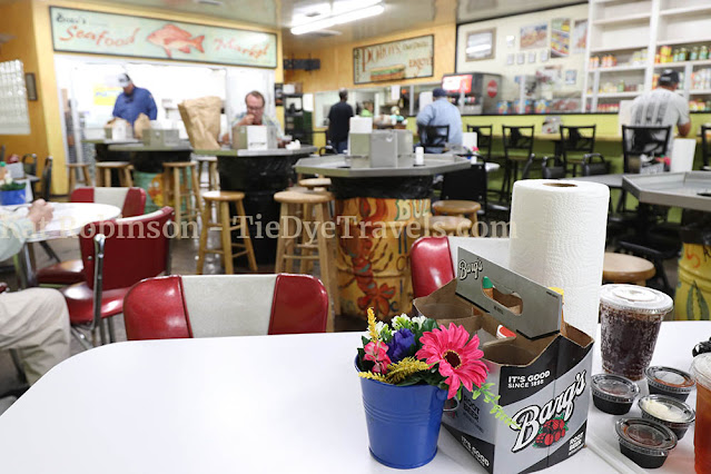 Inside Bozo's Grocery, a host of tables in the front, with separate counters for boiled and fried seafood in the back.