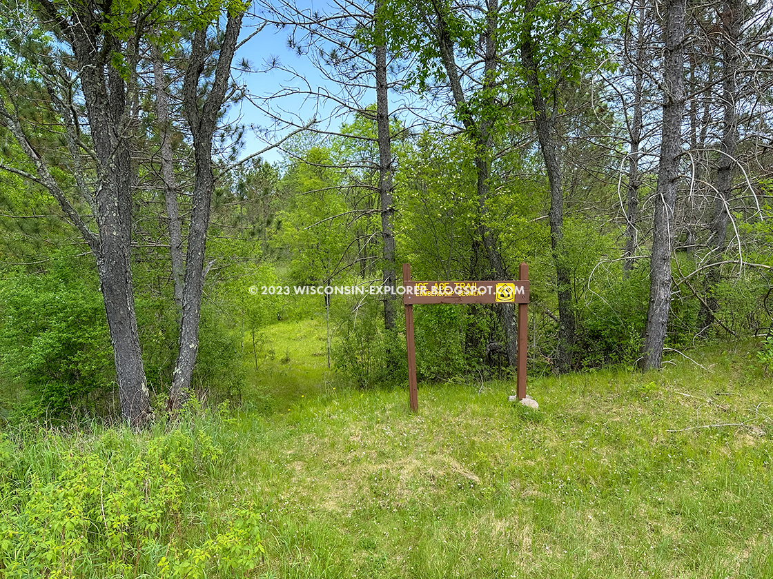 trailhead sign and grass trail