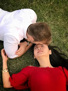 Image of two couples sleeping together on the grass.