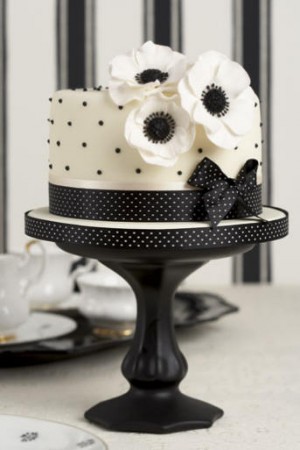 Simple and elegant round four tier wedding cake with white icing and black 