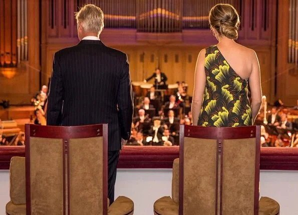 Queen Mathilde of Belgium wore a printed dress from Dries Van Noten SS 2018 collection, and she wore Natan pumps and carried Natan clutch